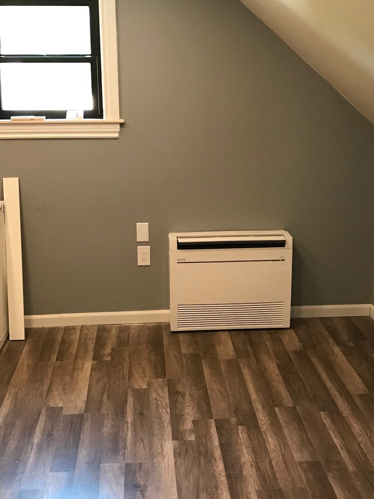 Floor-mounted ductless console unit installed in a finished room by Pro Air Care HVAC